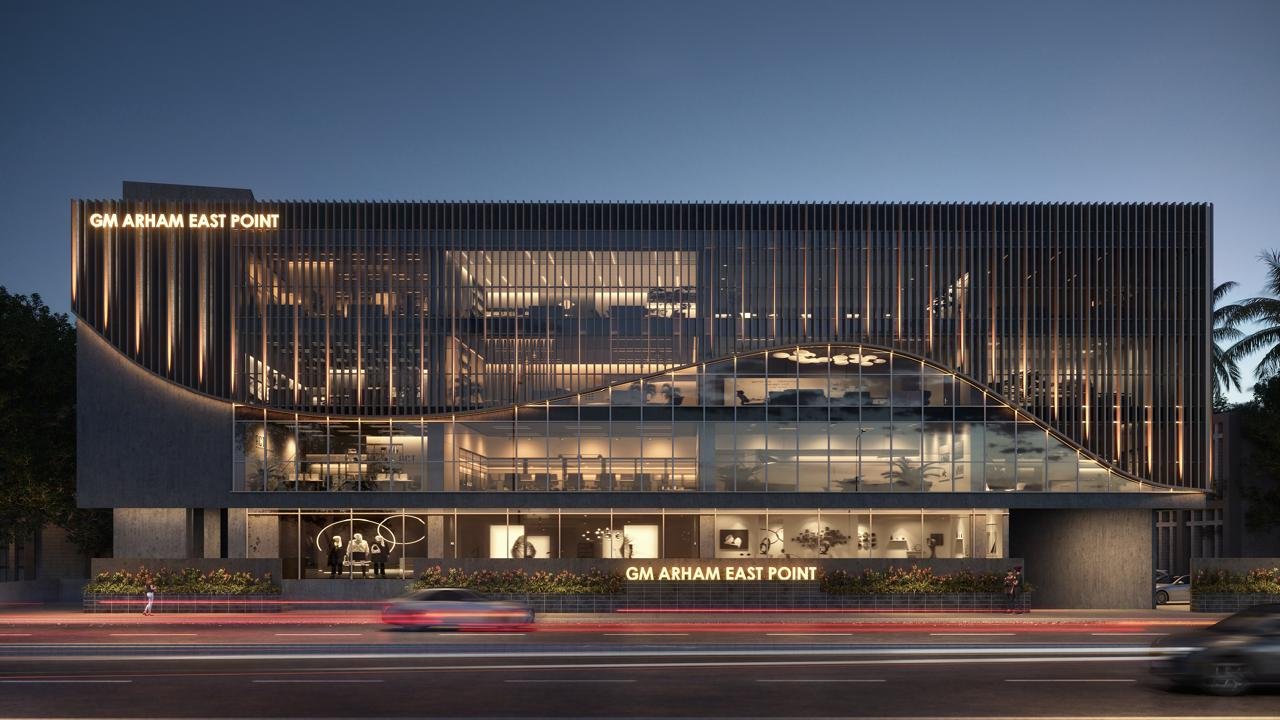 Night view of GM Arham East Point with illuminated facade and signage