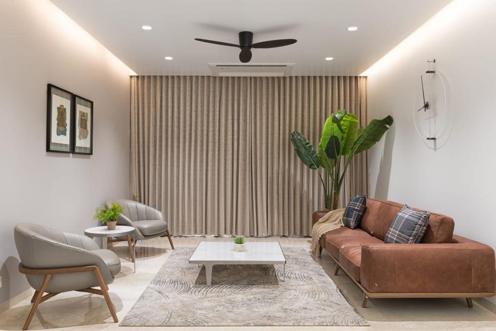 Residential living room with soft ceiling cove lighting and downlights