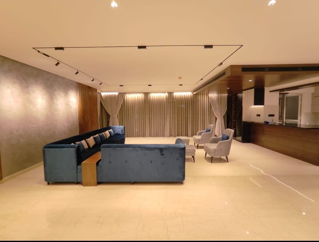 Residential lounge with ceiling track lights, downlights and curtain lighting